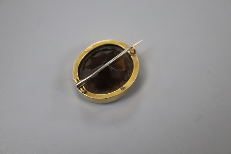An early 20th century 15ct mounted oval brown quartz brooch, 25mm, gross weight 10.6 grams.